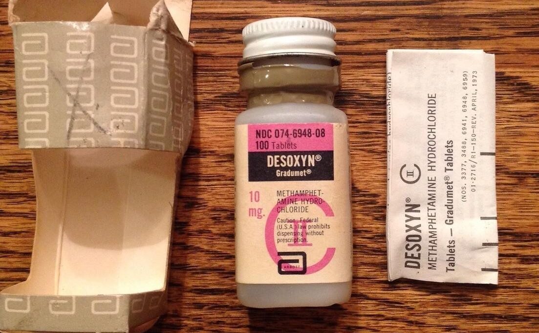 Bottle of Desoxyn (10 mg) with original packaging and a folded informational insert beside it.