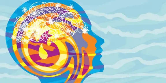 Colorful silhouette of a head with a chaotic brain, featuring swirls and bright elements against a soft blue background.