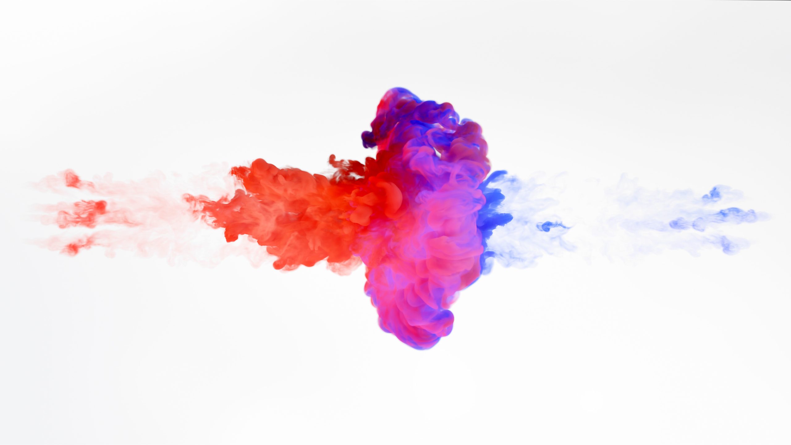 Colorful smoke swirls in red, purple, and blue against a white background, creating a dynamic, abstract pattern.