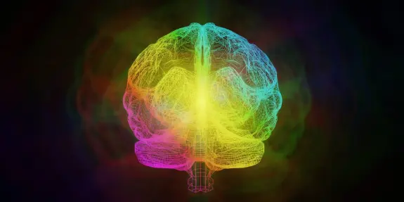 Colorful wireframe representation of a brain, radiating vibrant hues against a dark background.