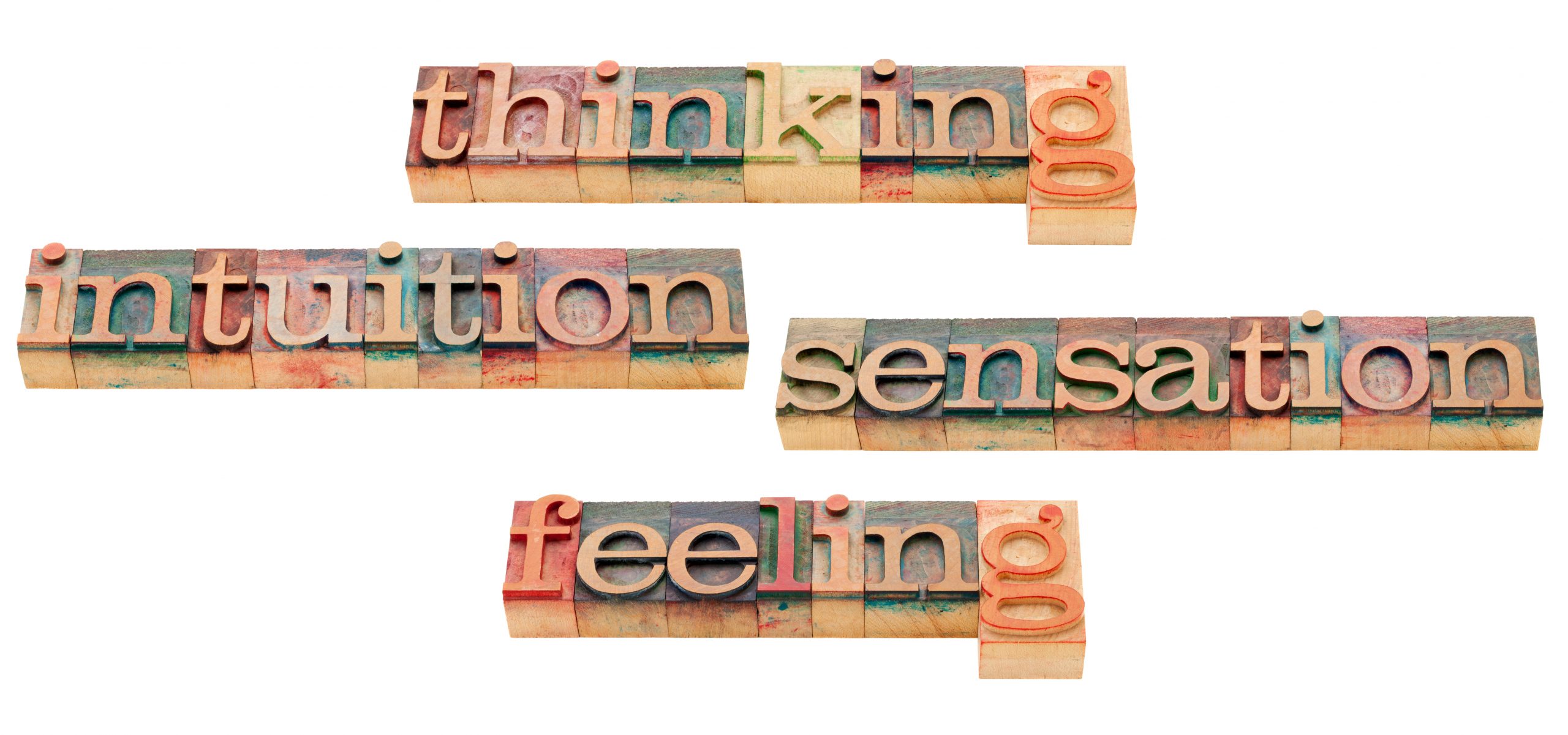 Colorful wooden blocks spell out "thinking," "intuition," "sensation," and "feeling" in a playful arrangement.