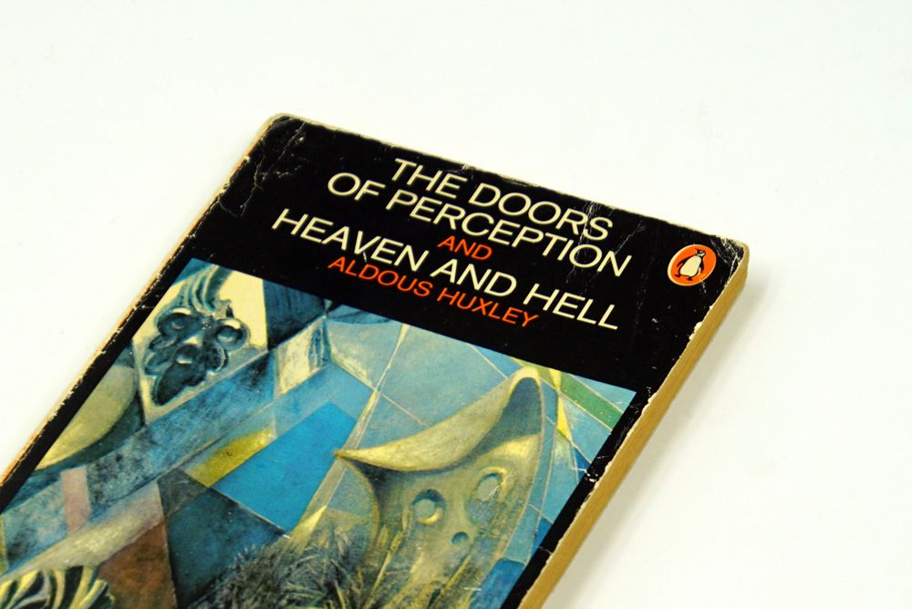 Cover of "The Doors of Perception and Heaven and Hell" by Aldous Huxley, featuring abstract art and bold typography.