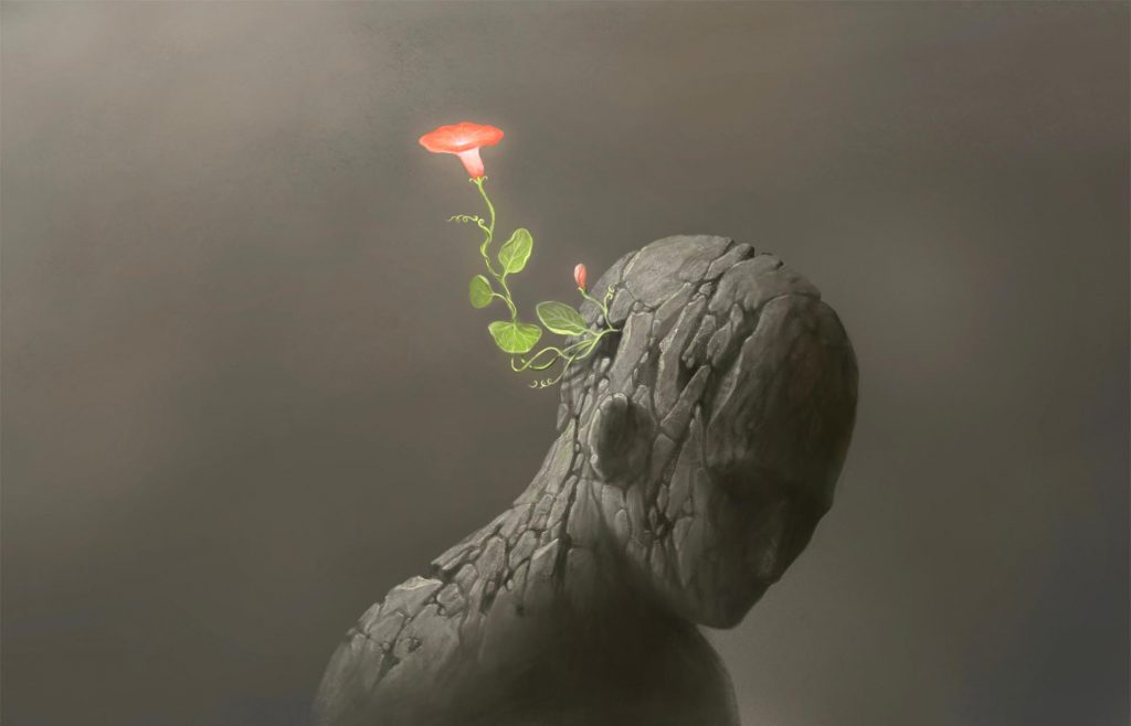A cracked, gray figure with a flower sprouting from its head, symbolizing growth and resilience amidst despair.