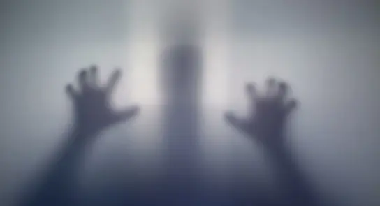 Faint silhouette of a person with hands pressed against a translucent surface, creating a haunting, ethereal effect.