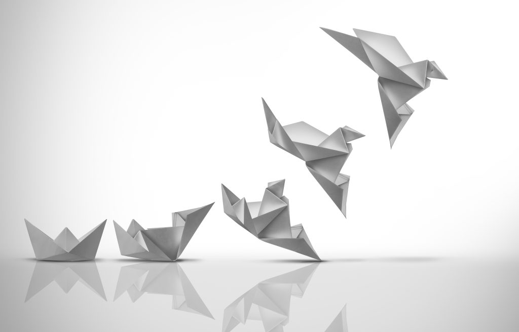 Five white origami figures: three boats and two birds, floating against a clean, white background.