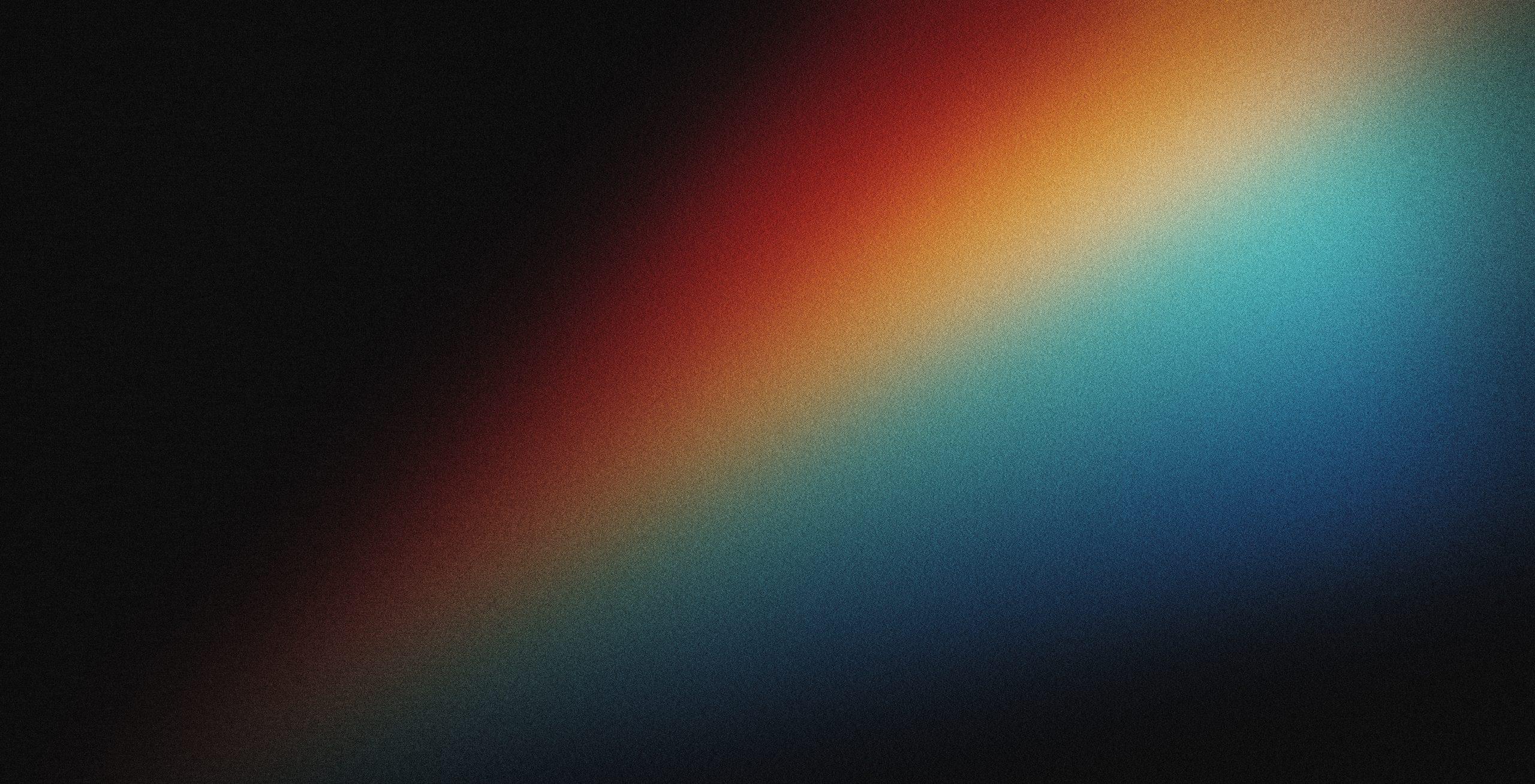 A gradient of vibrant colors transitions from deep red to bright blue against a dark background.