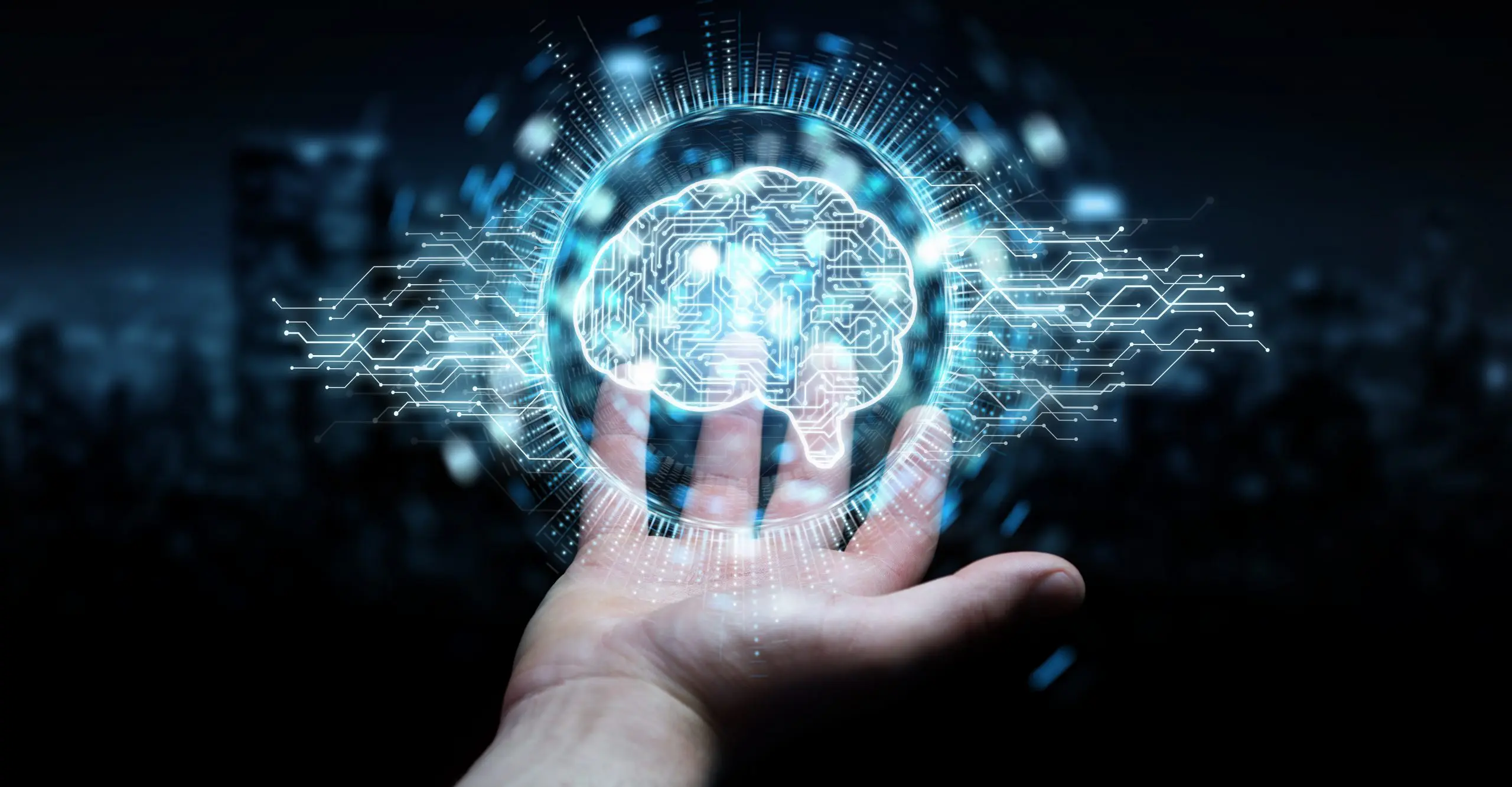 A hand holds a glowing, digital brain surrounded by circuit patterns, symbolizing artificial intelligence and technology.