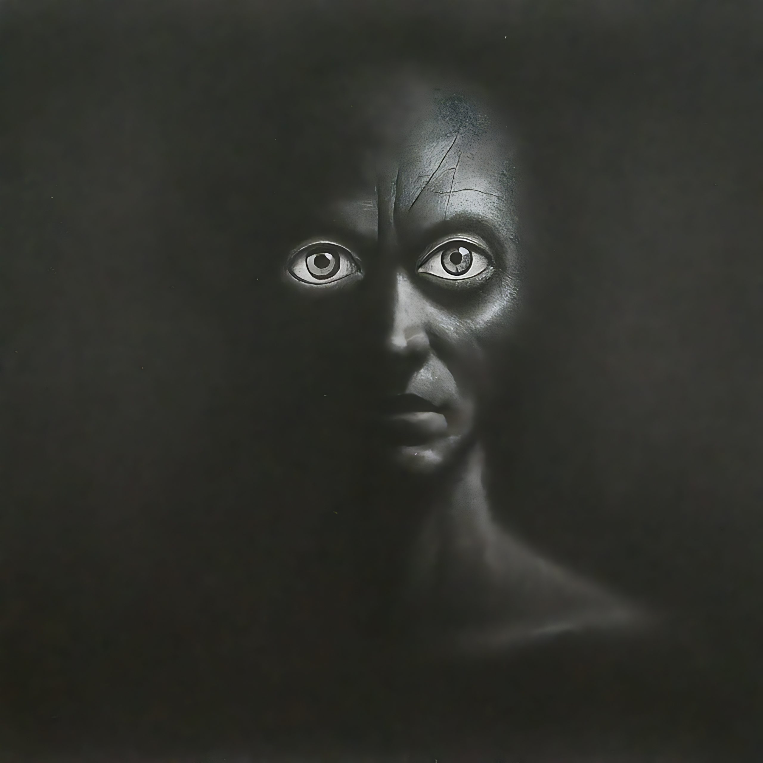 A haunting face emerges from darkness, featuring strikingly bright eyes and deep shadows highlighting its features.