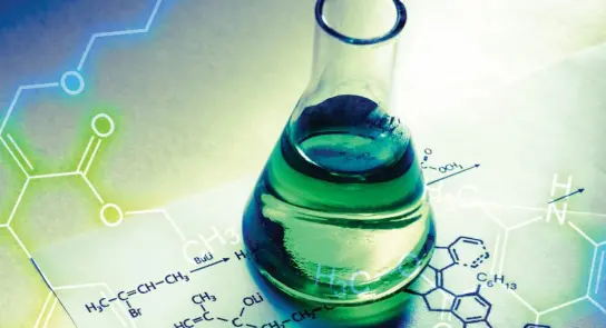 Green liquid in a glass flask on a sheet of paper with chemical formulas and molecular structures.