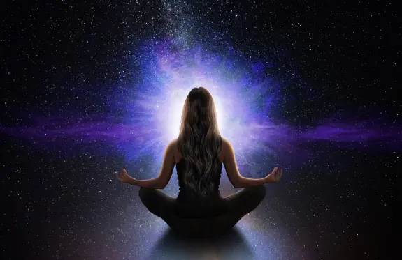 A woman meditates in a cosmic space, surrounded by vibrant purple and blue light against a starry background.