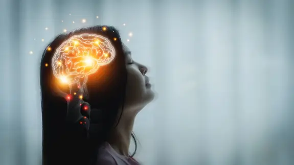 A woman in profile with a glowing brain illustration above her head, symbolizing thought and creativity.