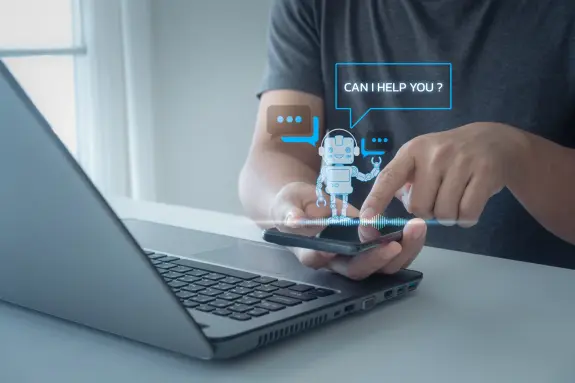 A person interacts with a smartphone displaying a virtual assistant robot, with speech bubbles asking, "Can I help you?