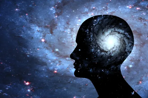 Silhouette of a human head filled with a swirling galaxy against a starry background, symbolizing cosmic thoughts.
