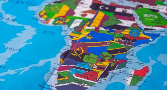 Colorful map of Africa highlighting countries with distinct borders and symbols, set against a blue background.