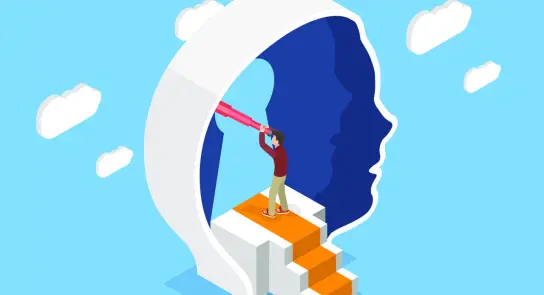 A person stands on stairs inside a large head silhouette, using a telescope to gaze into the distance against a blue sky.