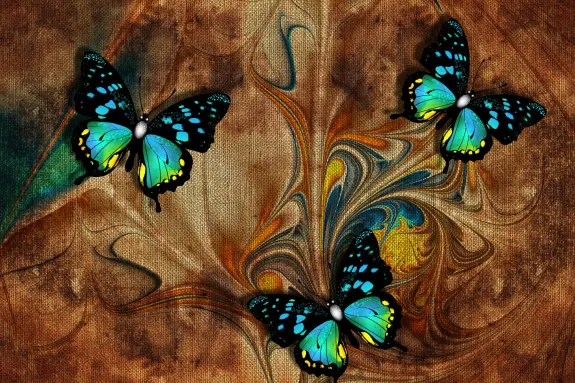 Three vibrant blue and yellow butterflies flutter against a swirling brown and orange abstract background.
