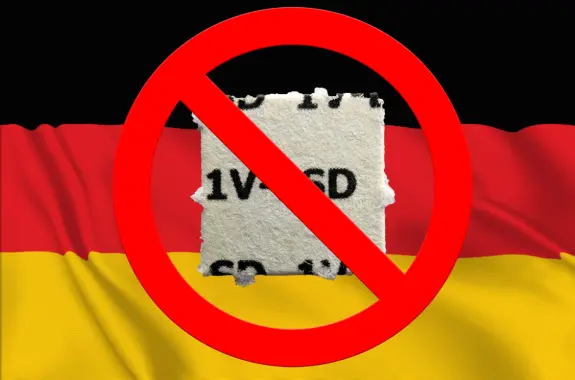 A torn paper with "1V5CD" is centered over a red circle with a diagonal line, set against a German flag background.