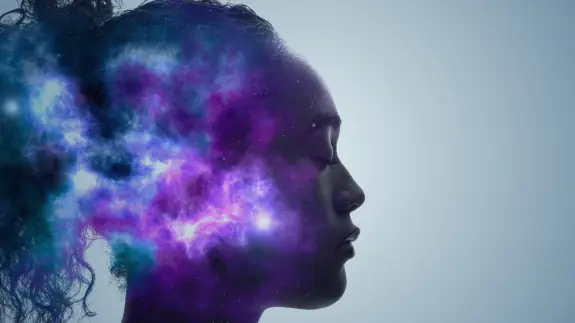 Silhouette of a woman with a cosmic nebula emerging from her head, blending purple and blue hues against a light background.