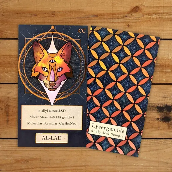 A colorful illustration of a fox with three eyes, alongside a patterned card featuring geometric shapes and text about Lys...