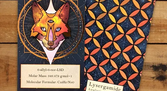 A colorful illustration of a fox with three eyes, alongside a patterned card featuring geometric shapes and text about Lys...