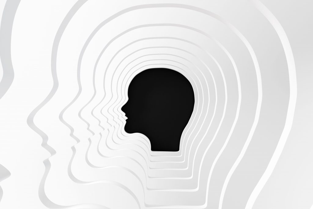 Layered white silhouettes of human heads create a tunnel effect, with a solid black silhouette at the center.