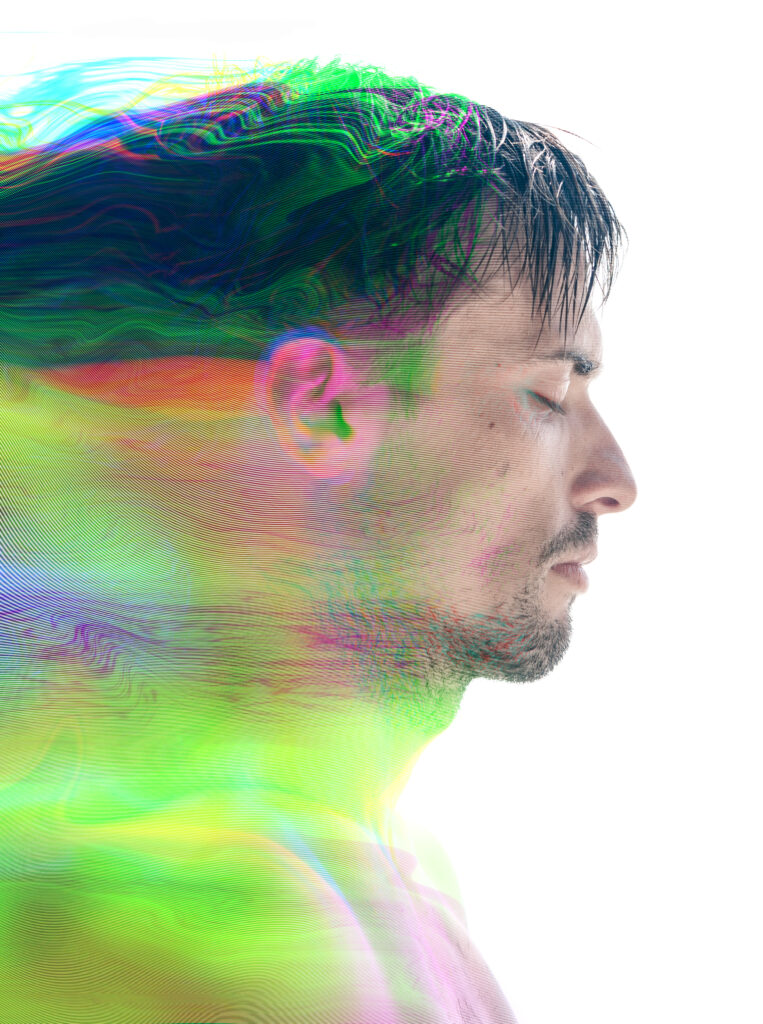 A man with closed eyes, surrounded by vibrant, swirling colors that create a dreamlike effect.