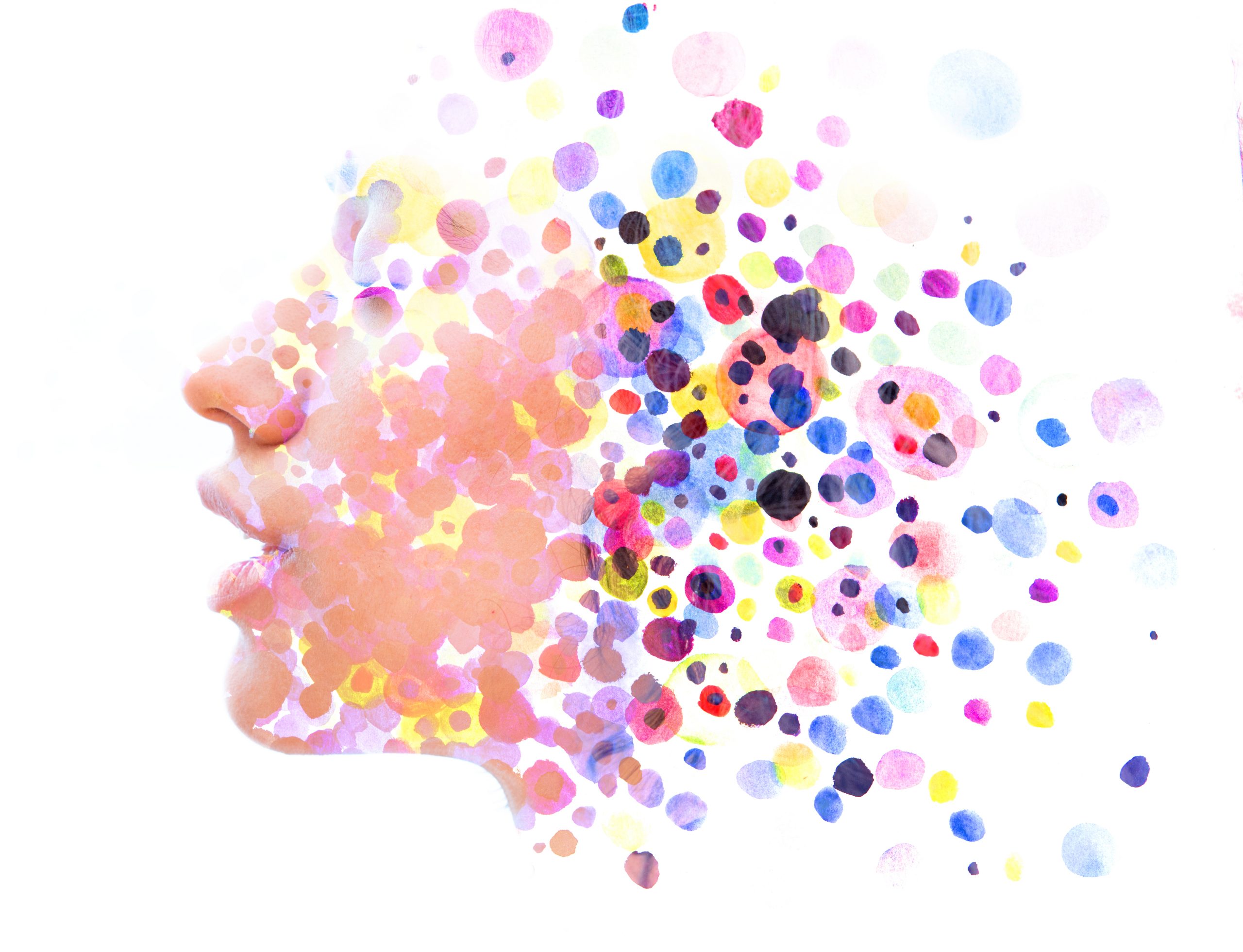 Profile of a face blending with colorful, abstract dots, creating a dreamlike, artistic effect.