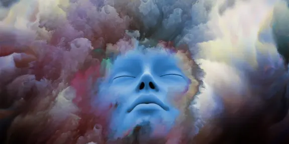 A serene blue face emerges from a swirling, colorful cloud of abstract patterns and textures.