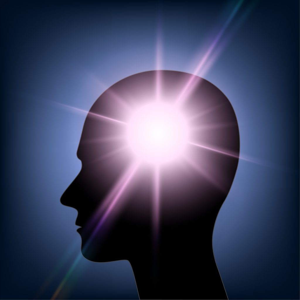 Silhouette of a human head with a glowing light emanating from the forehead against a dark blue background.
