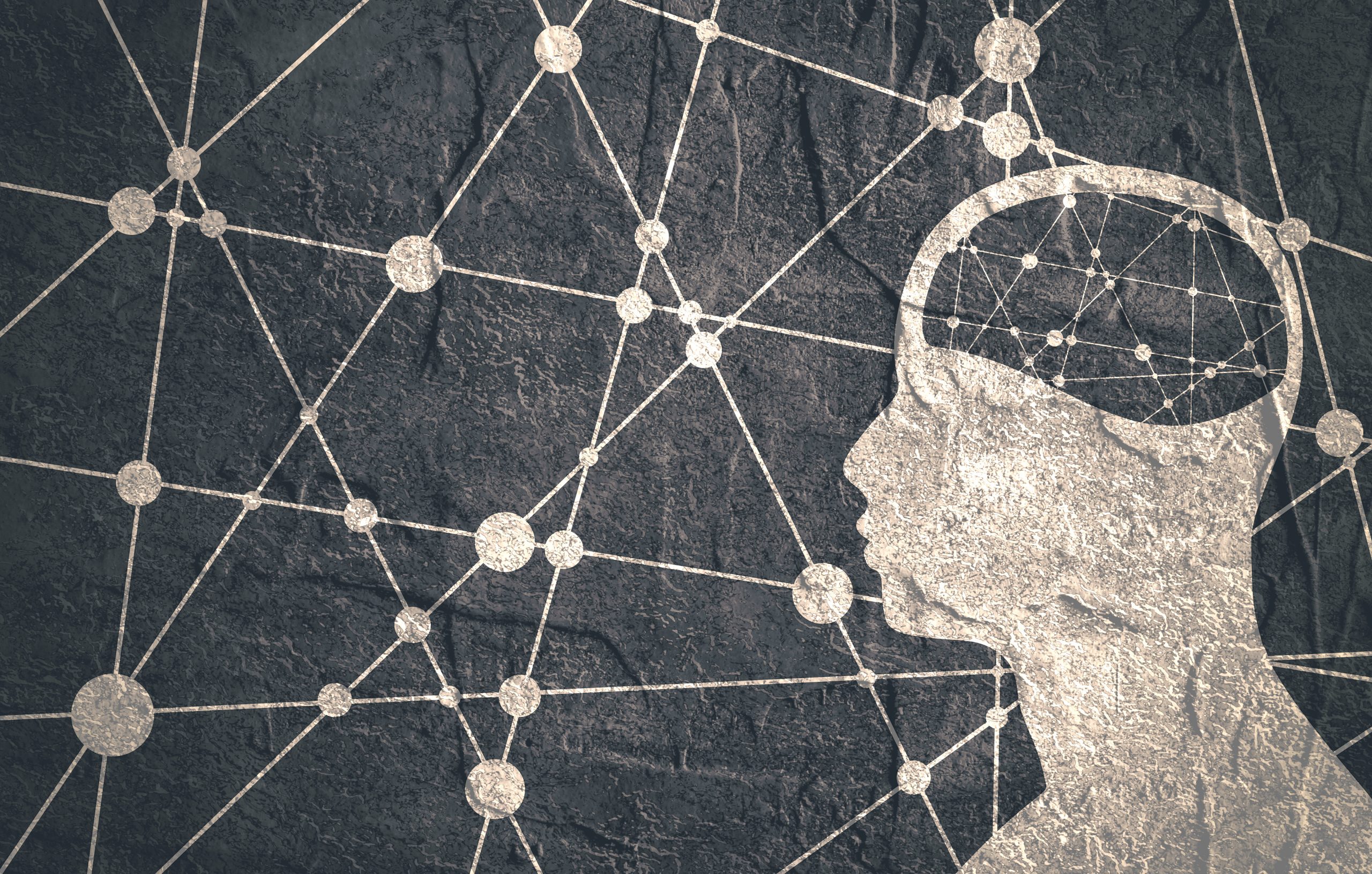 Silhouette of a human head with a network of interconnected nodes and lines, symbolizing thoughts and connections.