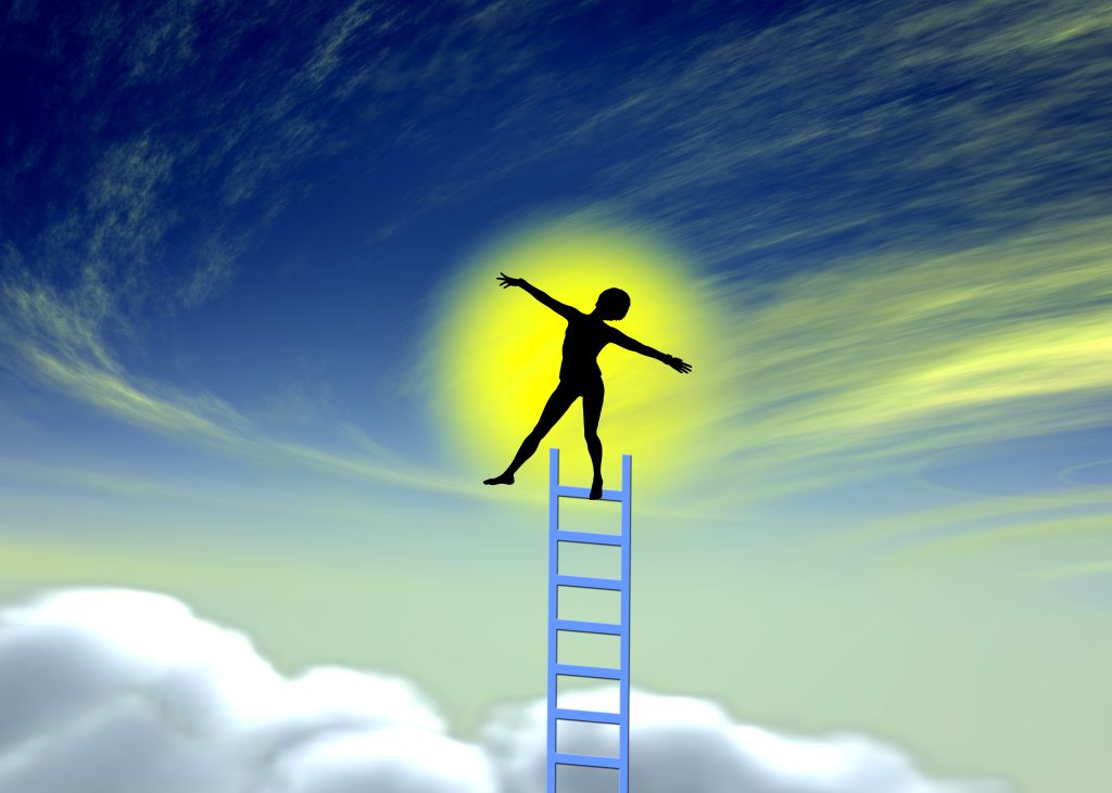 Silhouette of a person balancing on a blue ladder, reaching towards a bright sun against a vibrant sky.