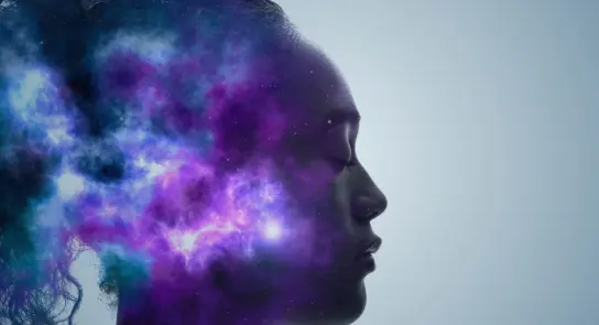 Silhouette of a woman with a cosmic nebula blending into her profile, showcasing stars and vibrant colors.