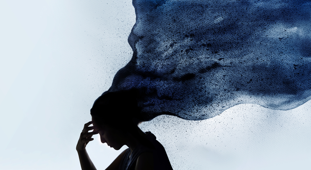 Silhouette of a woman with dark, flowing ink-like clouds emerging from her head, symbolizing thoughts or emotions.