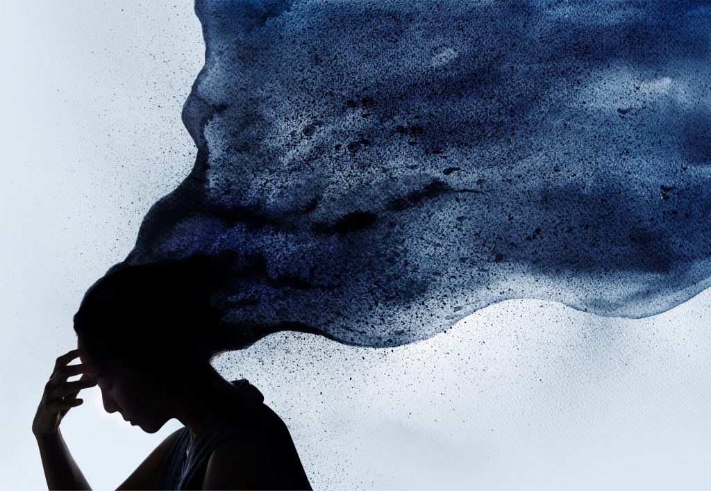 Silhouette of a woman with flowing blue ink-like clouds emerging from her head, symbolizing thoughts or emotions.