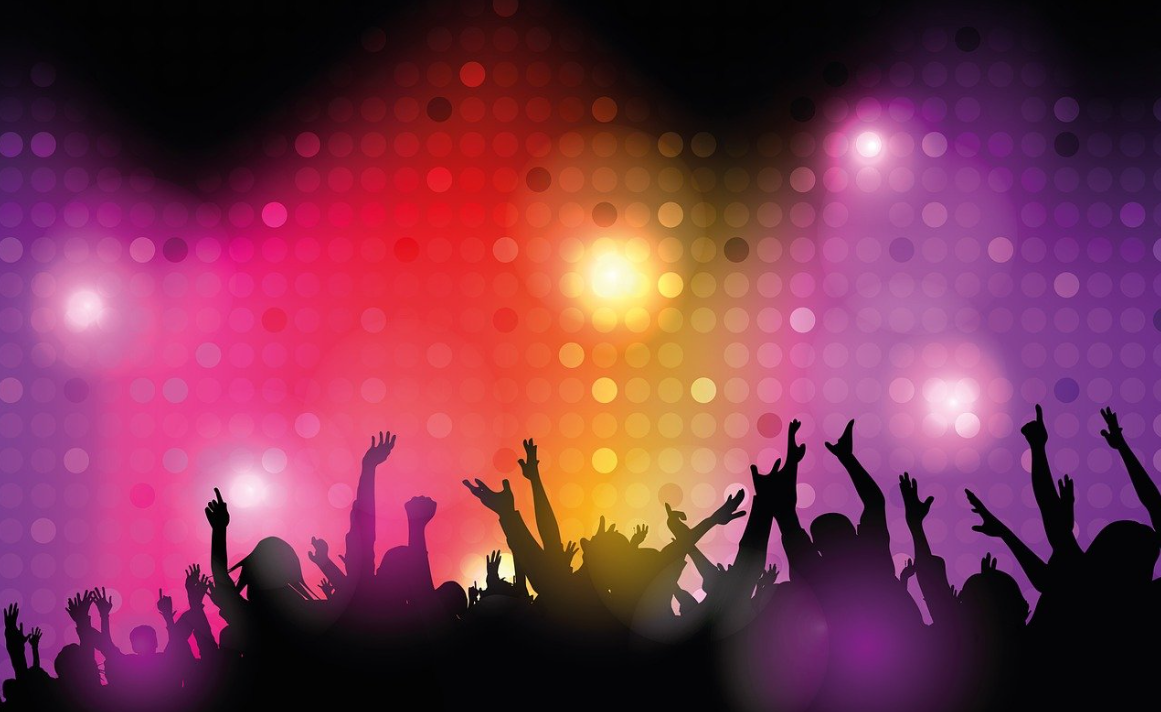 Silhouetted crowd with raised arms against a vibrant, colorful background of lights and dots.