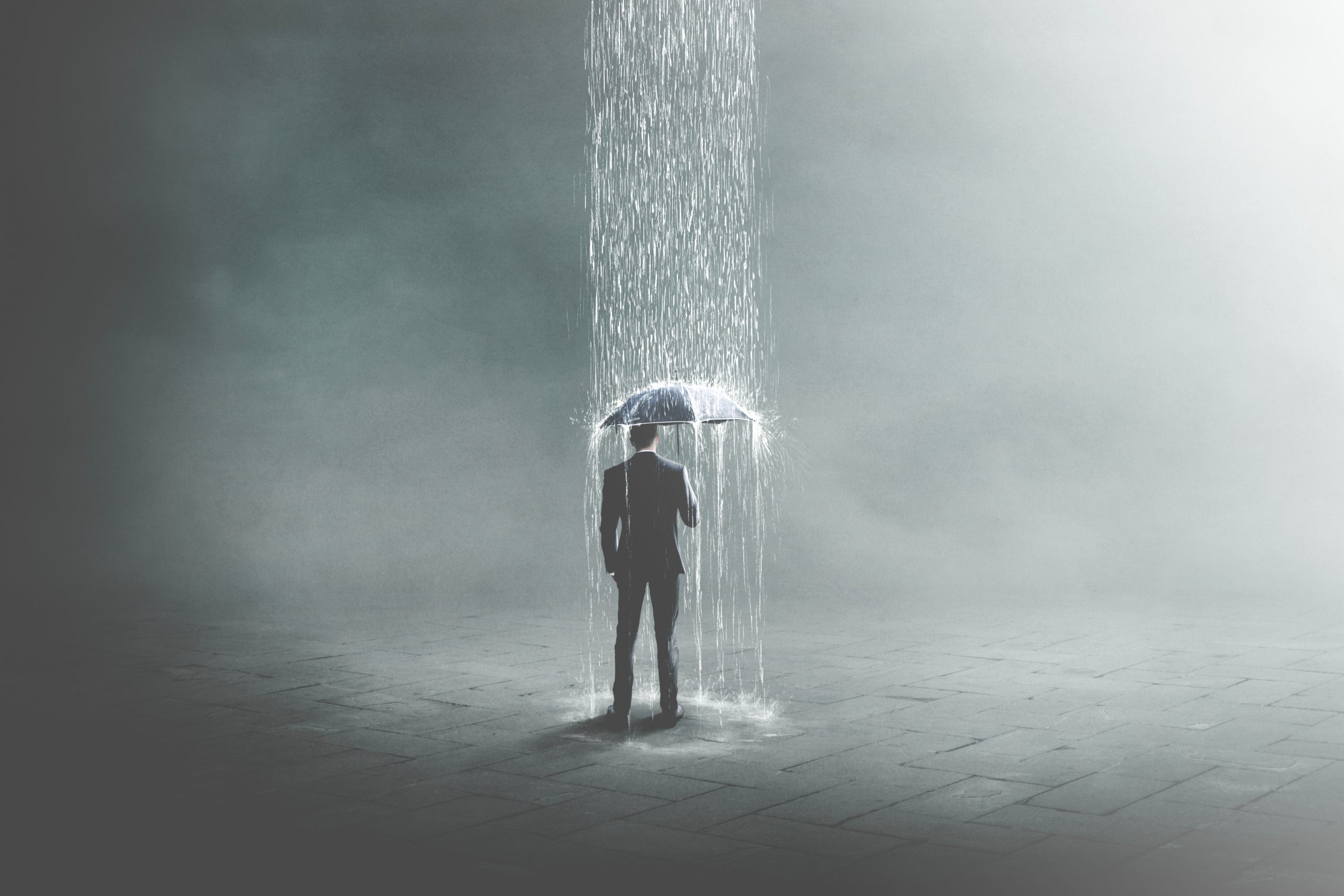 A silhouetted figure stands under an umbrella, surrounded by cascading water in a misty, atmospheric setting.