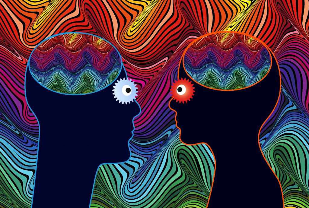 Silhouettes of two heads facing each other, with colorful, wavy patterns inside their brains against a vibrant background.