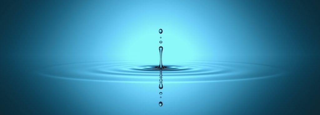 A single water droplet creates ripples in a serene blue background.