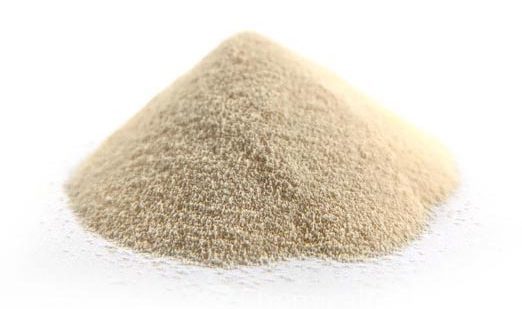 A small mound of fine, light brown powder on a white background.