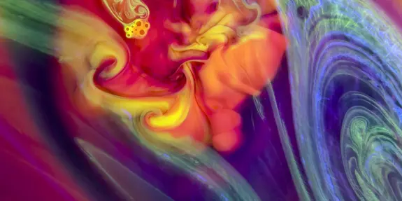 Swirling patterns of vibrant reds, yellows, and blues create an abstract, cosmic-like design.