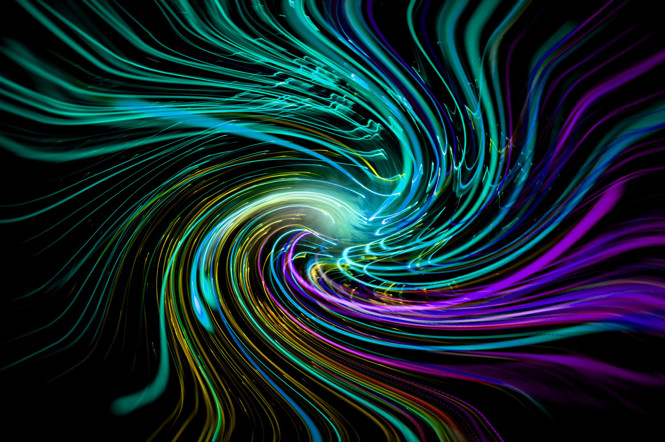 Swirling vortex of vibrant blue, green, and purple lines creating a dynamic, abstract pattern against a black background.
