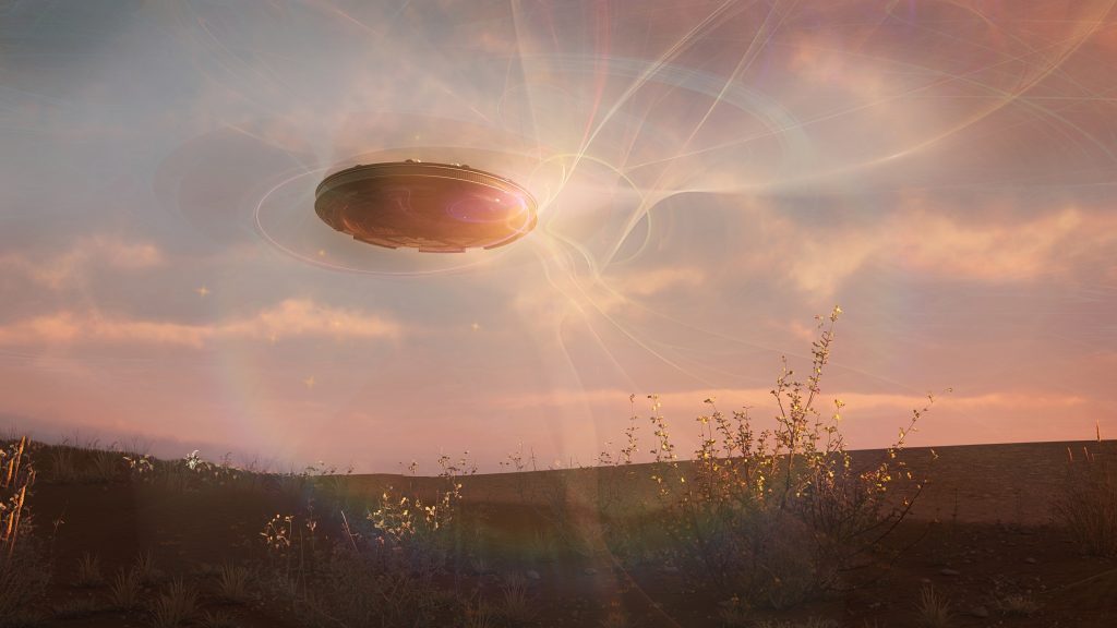A UFO hovers above a desert landscape, illuminated by a glowing sunset and surrounded by swirling light effects.