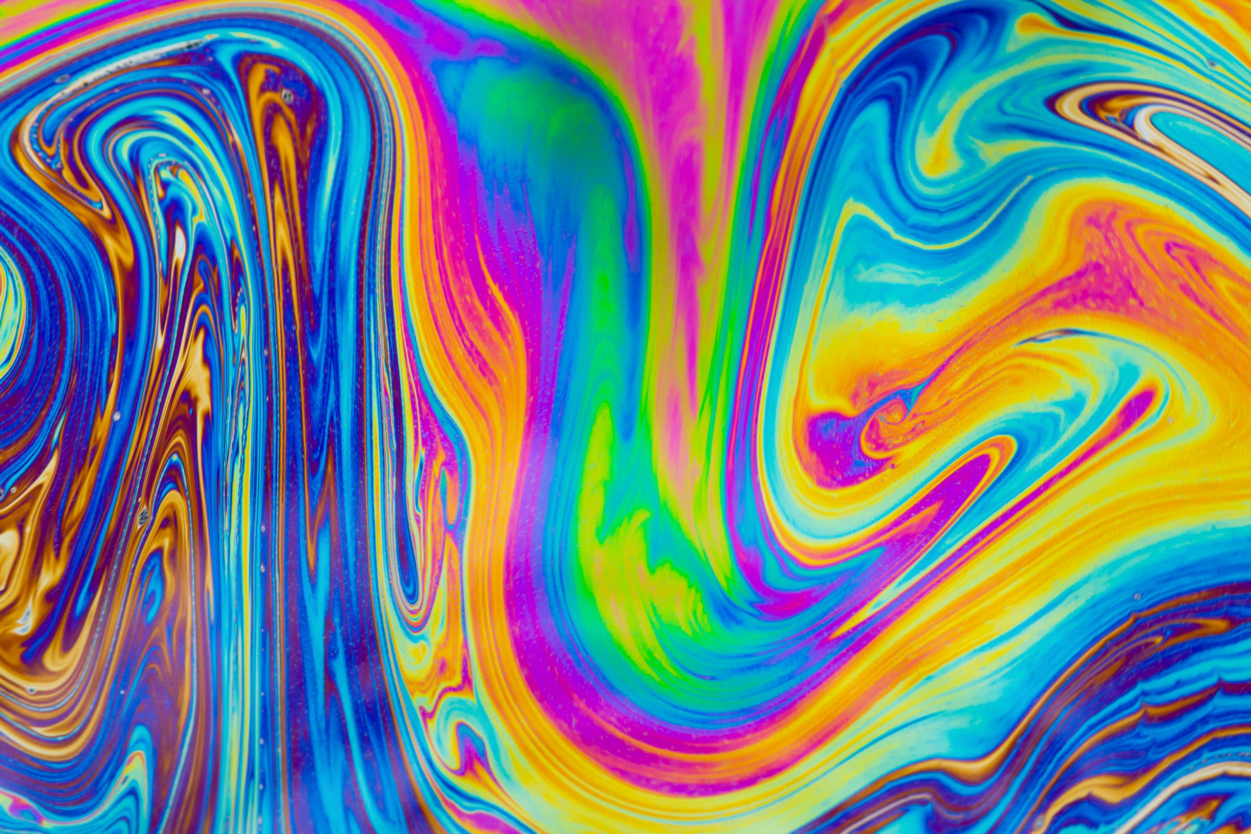 Vibrant swirls of blue, purple, yellow, and orange create a mesmerizing abstract pattern.