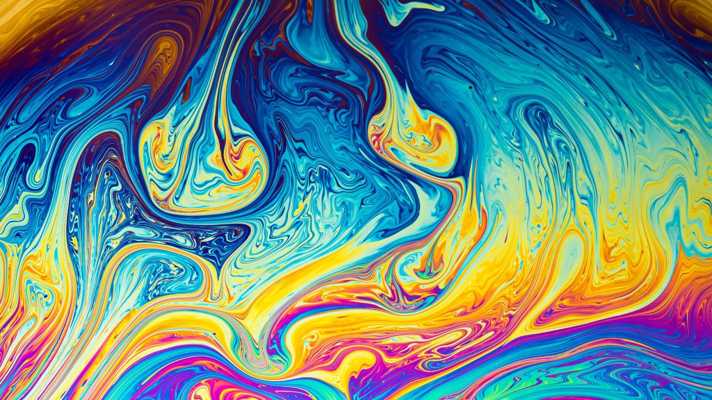 Vibrant swirls of blue, yellow, and orange create a mesmerizing abstract pattern reminiscent of flowing liquid.