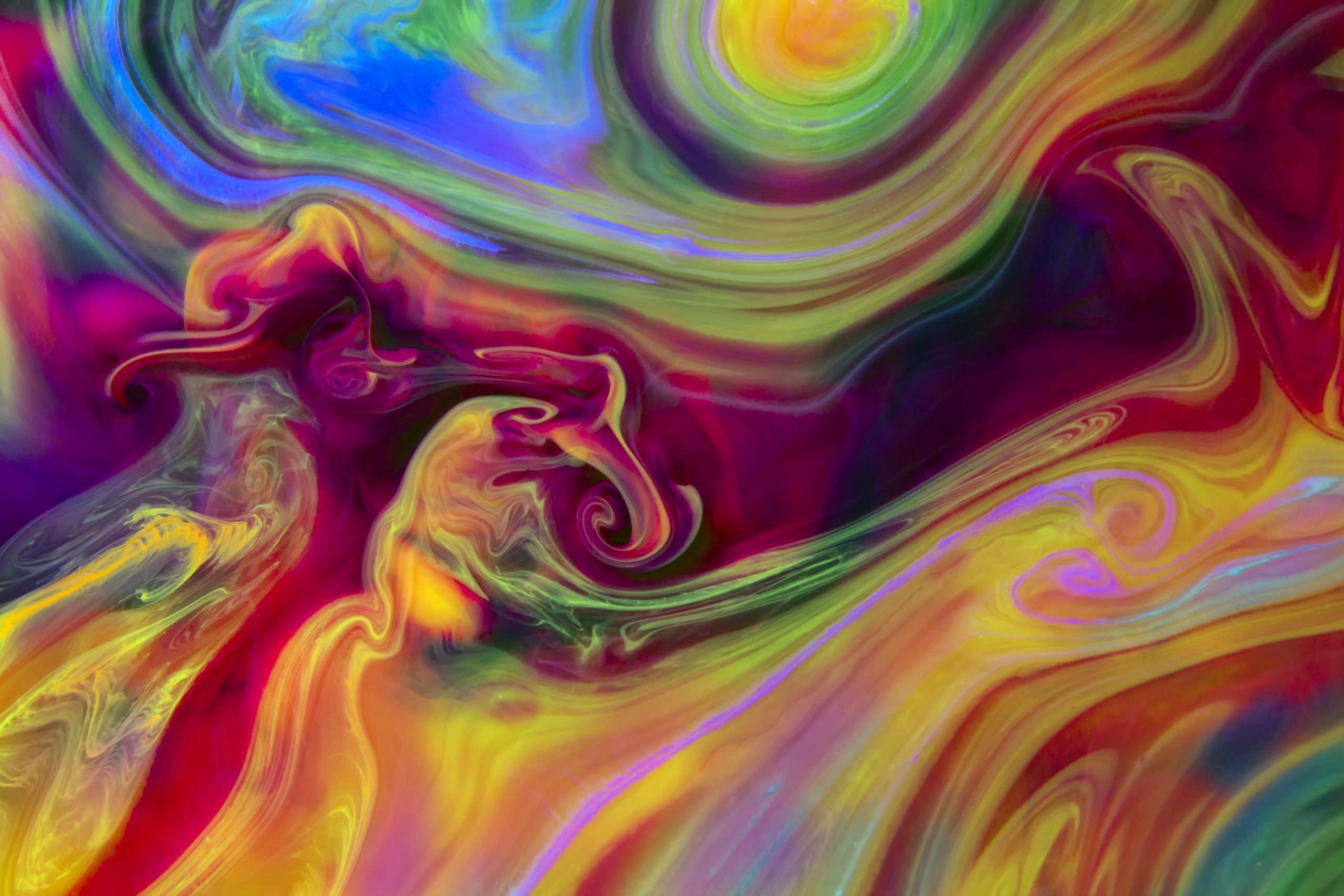 Vibrant swirls of red, yellow, green, and blue create a mesmerizing abstract pattern.