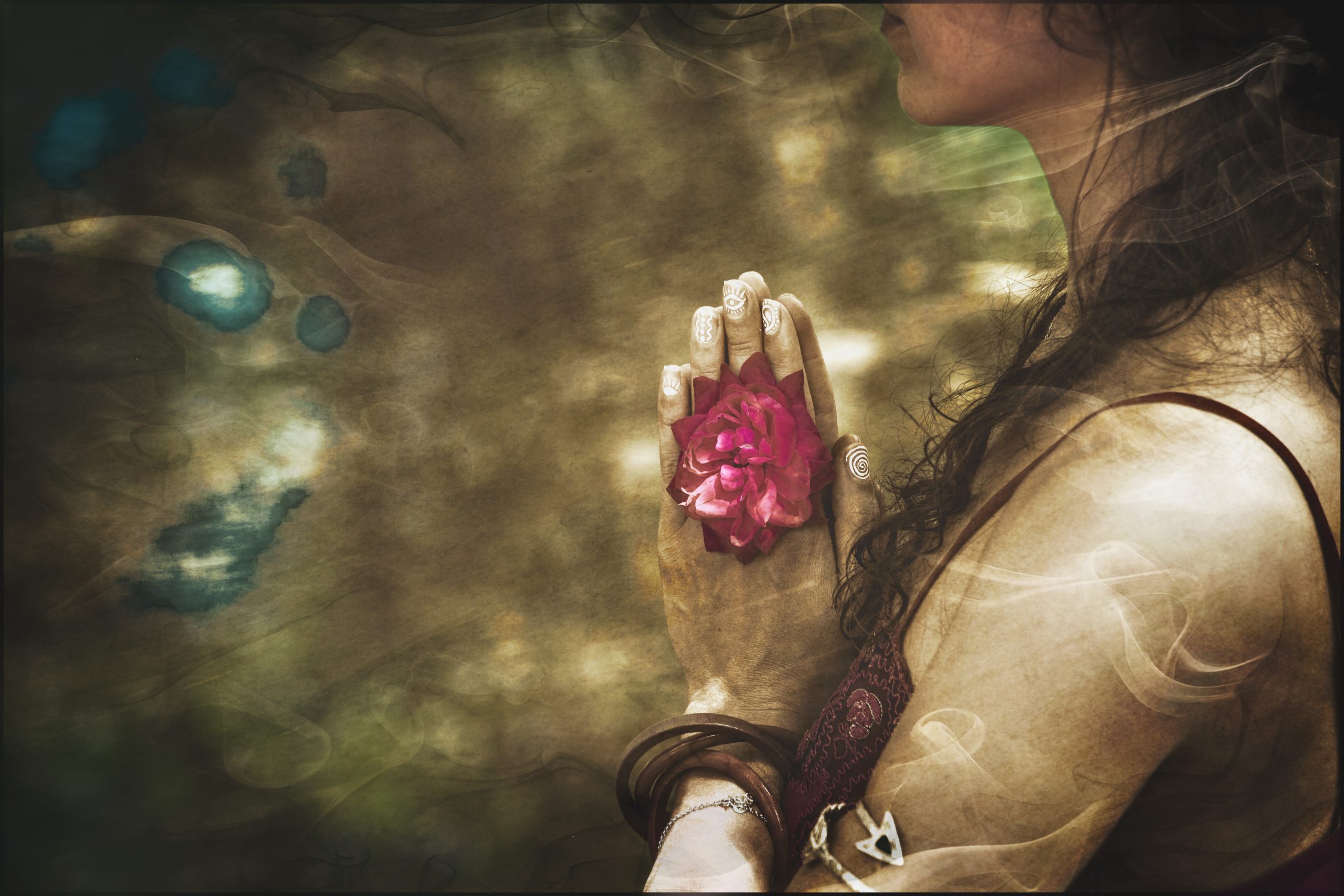 A woman with long hair holds a pink rose close to her chest, surrounded by soft, ethereal swirls of color.