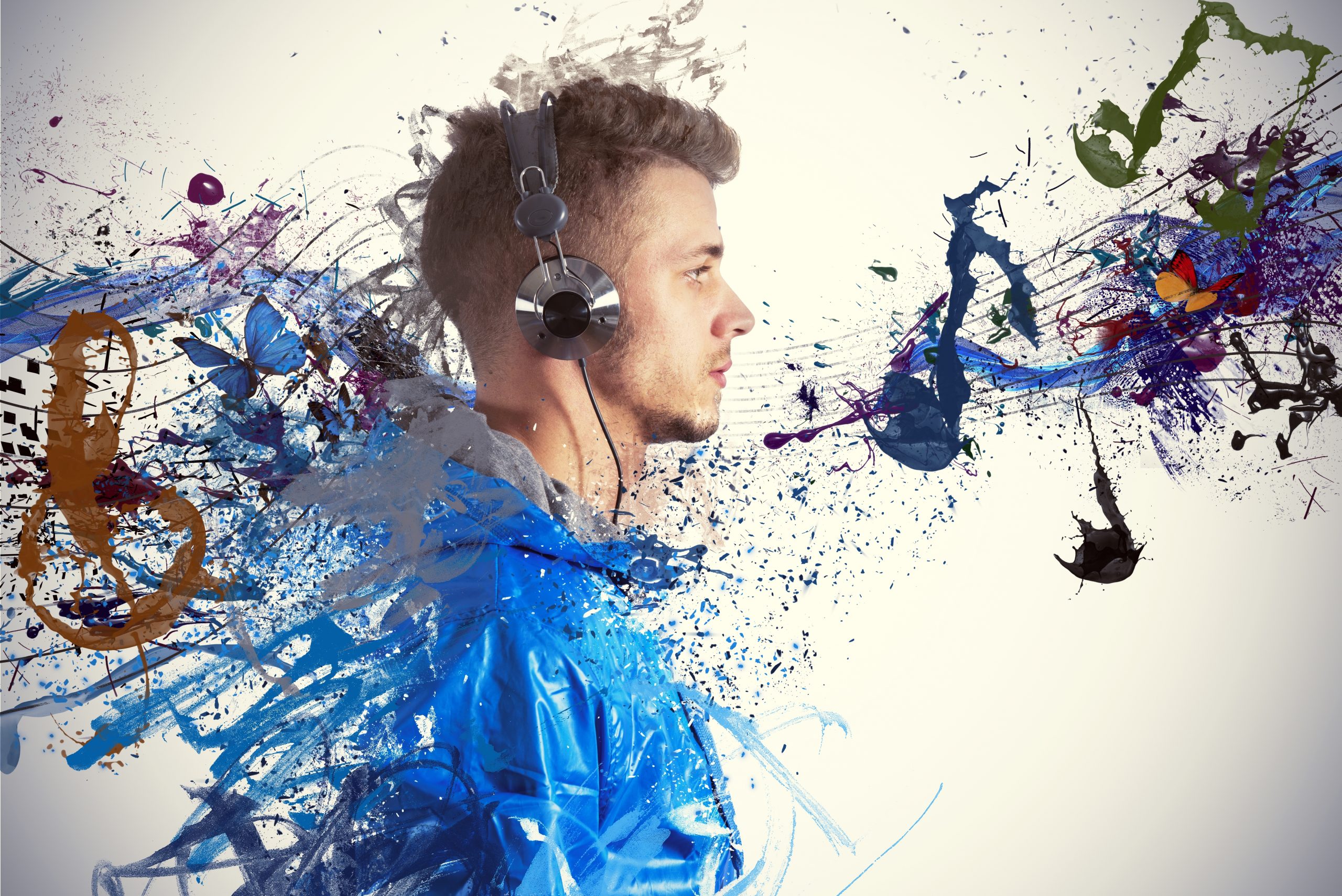 Young man in headphones with colorful paint splashes and musical notes swirling around him, creating a vibrant atmosphere.